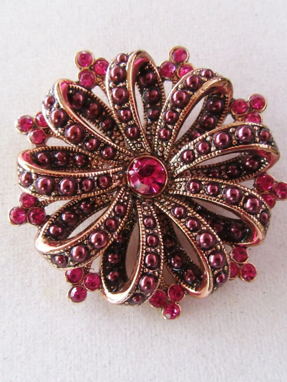 Liz Claiborne copper ribbon brooch with red & pink rhinestones